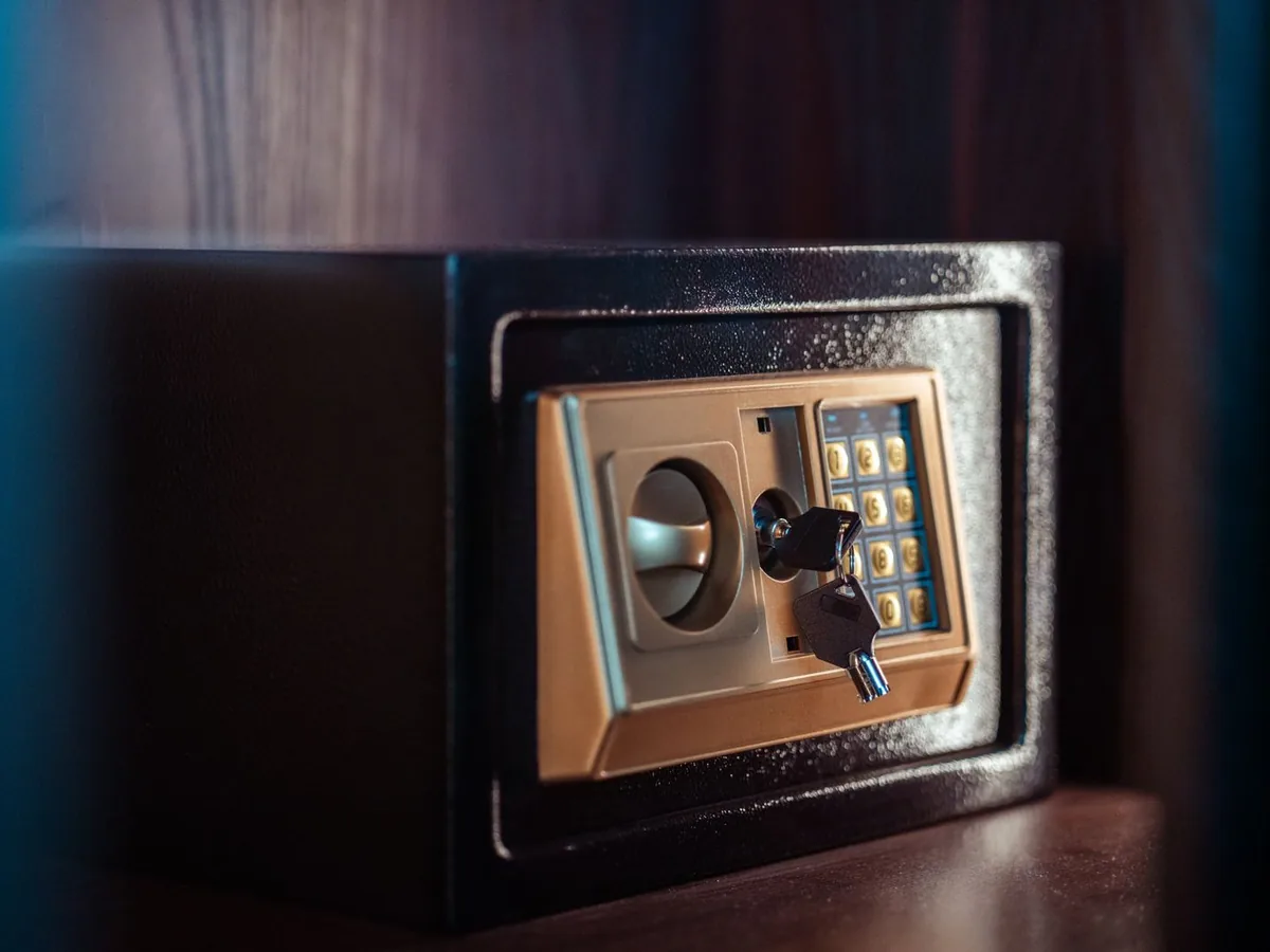 Small electronic safe with a keypad and a key in the lock